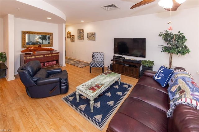 living room with ceiling fan and light hardwood / wood-style floors