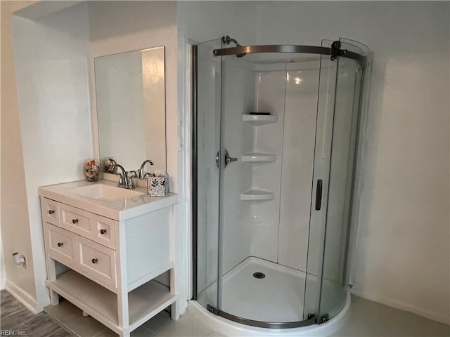 bathroom featuring vanity and a shower with door