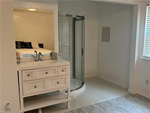 bathroom with an enclosed shower, vanity, and tile floors