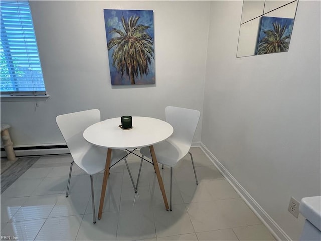 dining room with a baseboard heating unit and light tile flooring