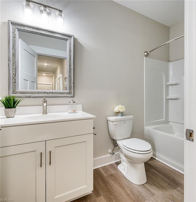 full bathroom with toilet, vanity, hardwood / wood-style flooring, and bathing tub / shower combination