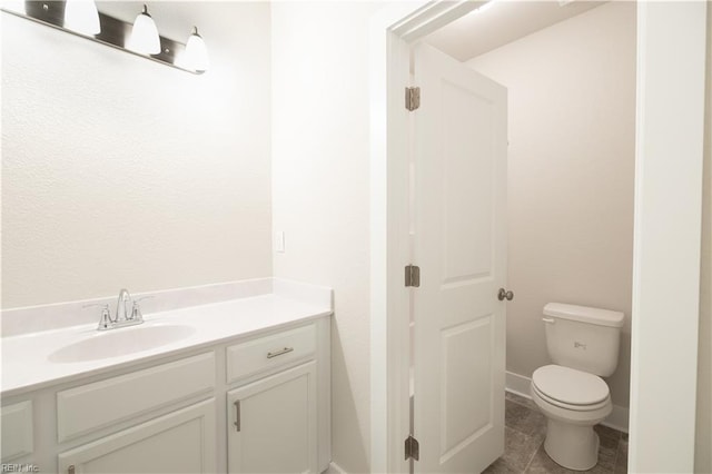 bathroom featuring tile patterned floors, toilet, and vanity