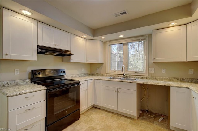 kitchen with white cabinets, black range with electric cooktop, light stone counters, and sink