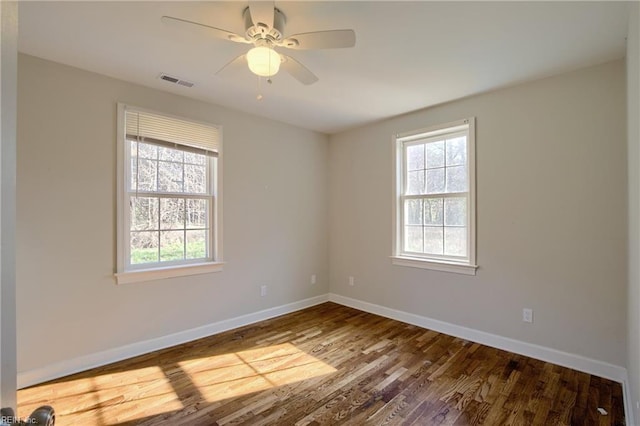 unfurnished room featuring hardwood / wood-style floors, plenty of natural light, and ceiling fan