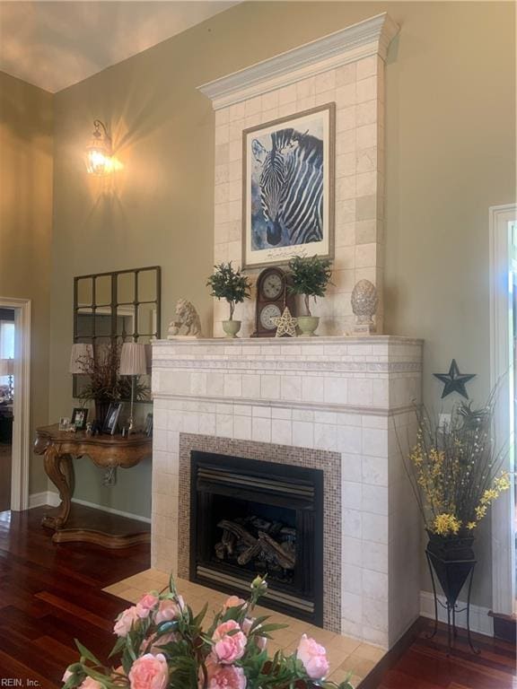 living room featuring wood-type flooring and a tile fireplace