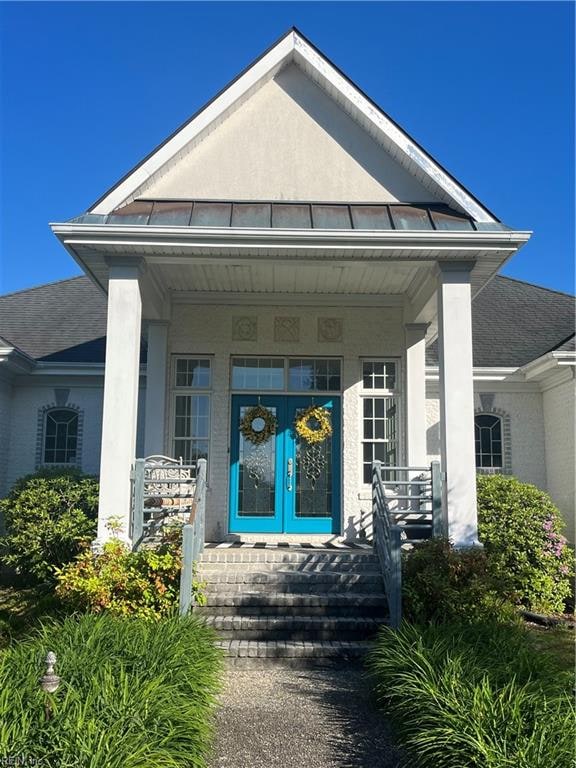 view of exterior entry featuring a porch