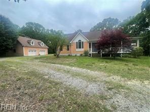 view of front of home featuring a garage, an outdoor structure, and a front yard