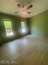 spare room with hardwood / wood-style floors and ceiling fan