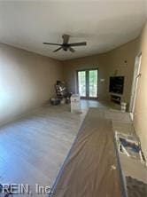 unfurnished living room with ceiling fan