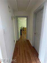 corridor with dark hardwood / wood-style flooring