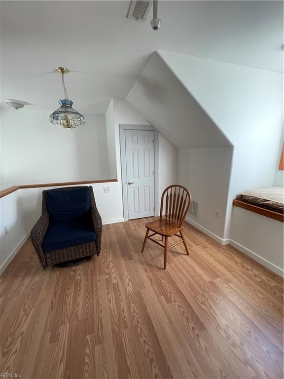 sitting room featuring light hardwood / wood-style floors and lofted ceiling