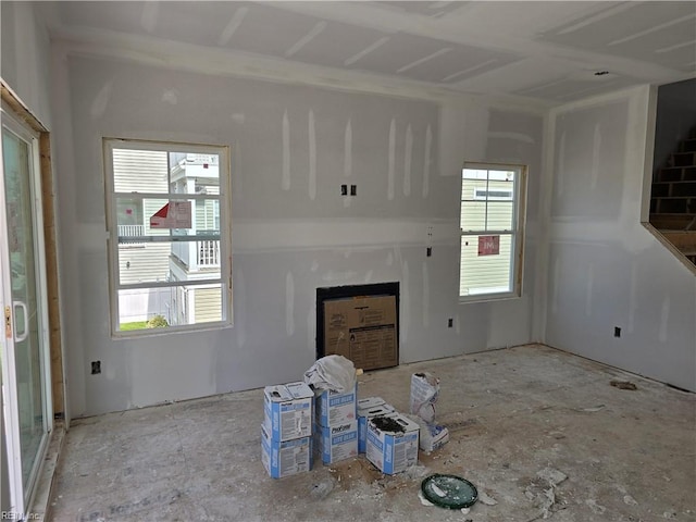 unfurnished living room featuring a healthy amount of sunlight