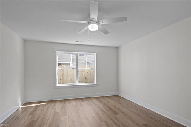 empty room featuring ceiling fan and light wood-type flooring