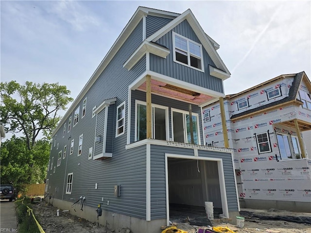 back of house featuring a garage