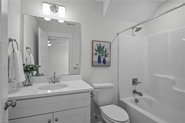 full bathroom featuring bathing tub / shower combination, ceiling fan, vanity, and toilet