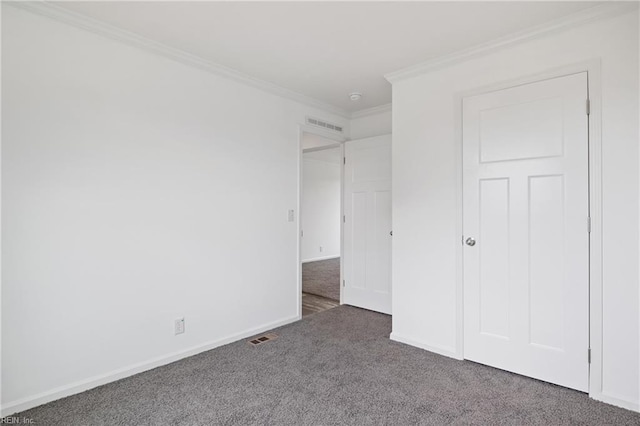 unfurnished bedroom with dark carpet and crown molding