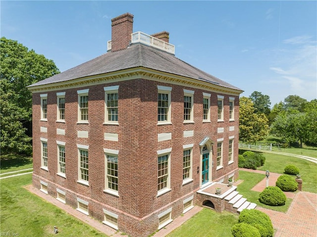 view of side of home featuring a lawn