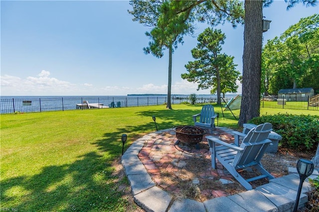 view of yard with a water view and an outdoor fire pit