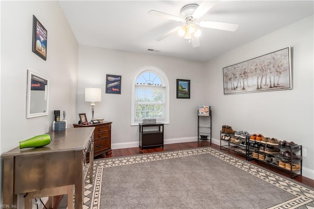 interior space with ceiling fan and dark hardwood / wood-style flooring