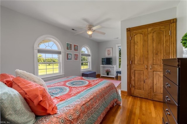 bedroom with ceiling fan and light hardwood / wood-style floors