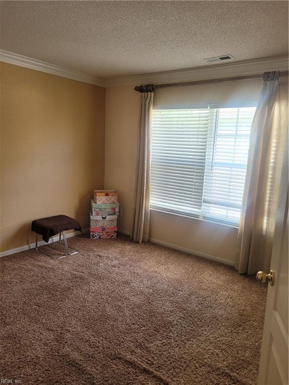 unfurnished room with a textured ceiling, crown molding, and carpet flooring