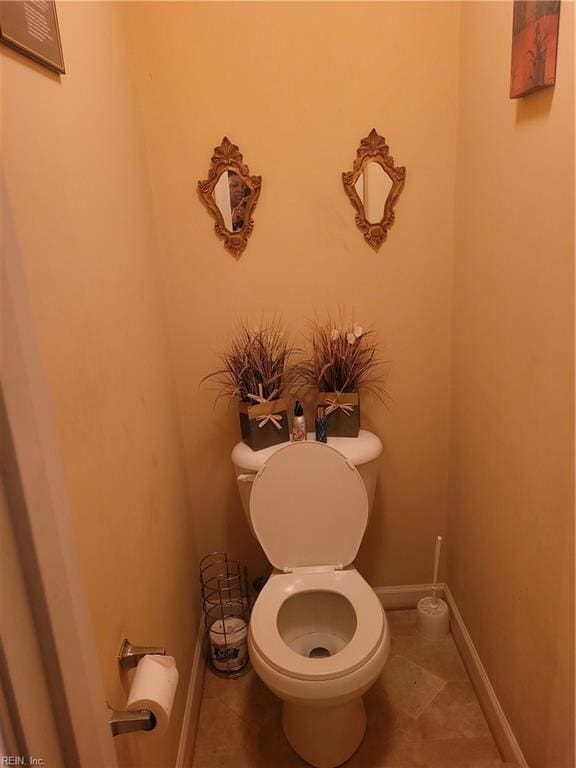 bathroom featuring tile flooring and toilet