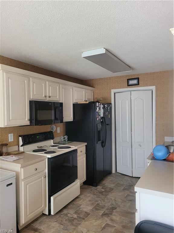 kitchen with white cabinets, black appliances, a textured ceiling, and light tile floors