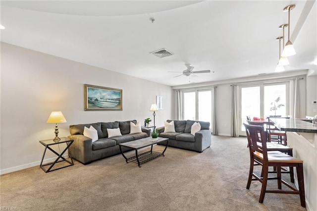 living room with light carpet and ceiling fan