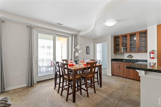 dining room featuring light colored carpet