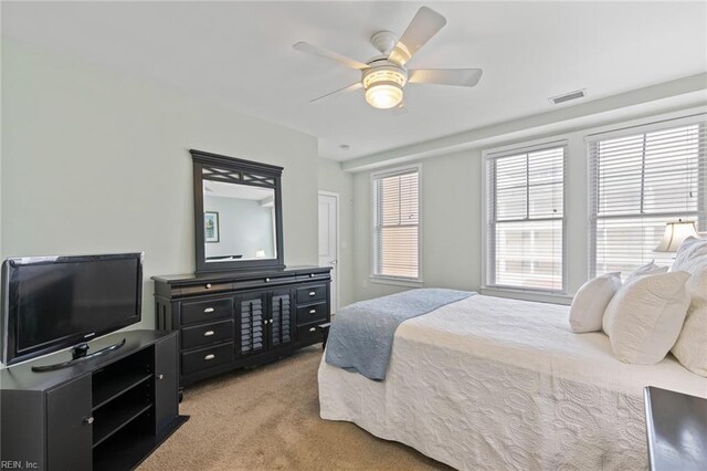 bedroom featuring light carpet and ceiling fan