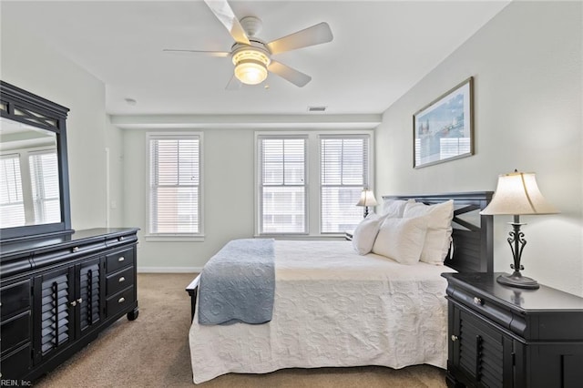 bedroom with multiple windows, carpet, and ceiling fan