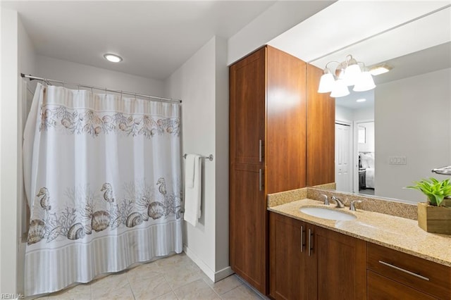 bathroom with vanity, tile patterned flooring, and a notable chandelier