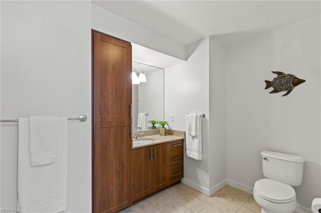 bathroom with vanity, tile patterned floors, and toilet