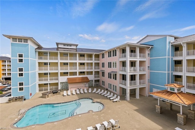 view of building exterior featuring a community pool