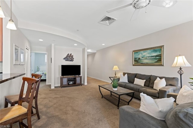 living room with light colored carpet and ceiling fan