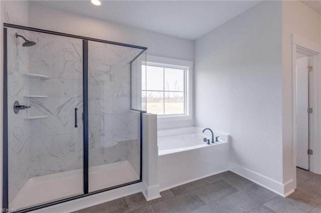 bathroom with tile patterned floors and independent shower and bath