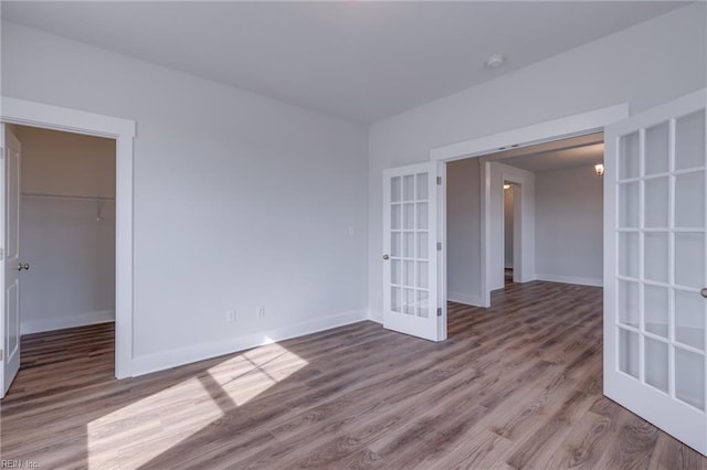 spare room featuring french doors and wood-type flooring