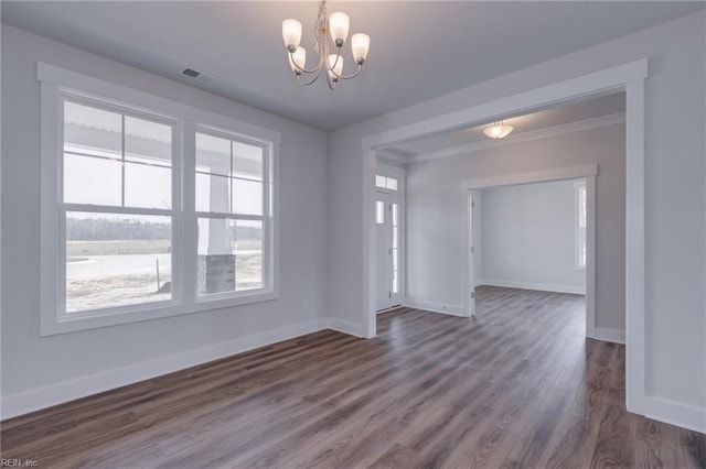 unfurnished room with an inviting chandelier and dark wood-type flooring