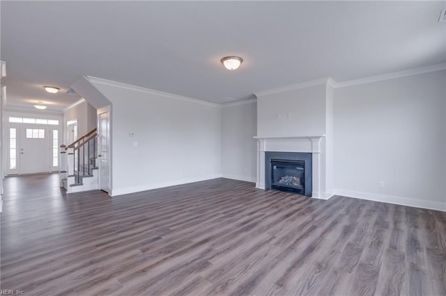 unfurnished living room with hardwood / wood-style floors and crown molding