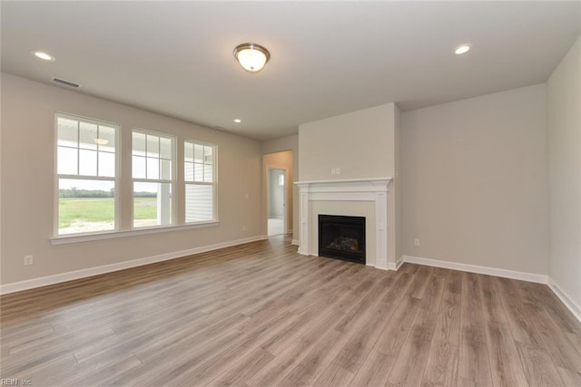 unfurnished living room with light hardwood / wood-style flooring