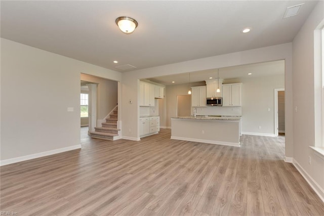 unfurnished living room with light wood-type flooring