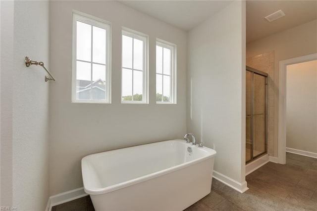 bathroom with tile floors and separate shower and tub