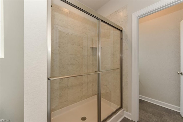 bathroom with tile flooring and an enclosed shower