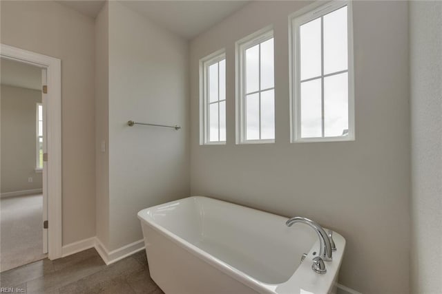 bathroom with tile floors and a tub