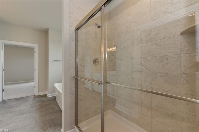 bathroom featuring shower with separate bathtub