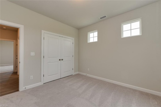 unfurnished bedroom with a closet and wood-type flooring