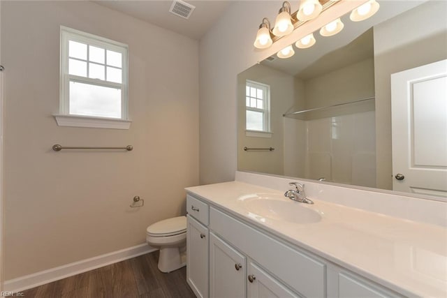 bathroom featuring hardwood / wood-style floors, oversized vanity, and toilet