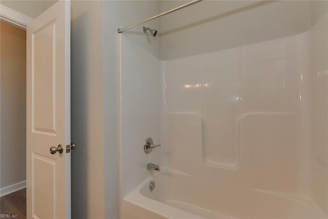 bathroom with shower / tub combination and hardwood / wood-style flooring