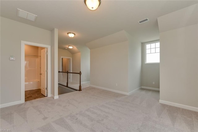 interior space featuring carpet and lofted ceiling