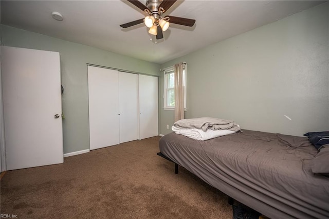 carpeted bedroom featuring ceiling fan and a closet